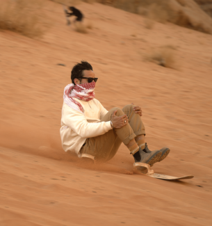 sand boarding in the dunes of Wadi Rum
